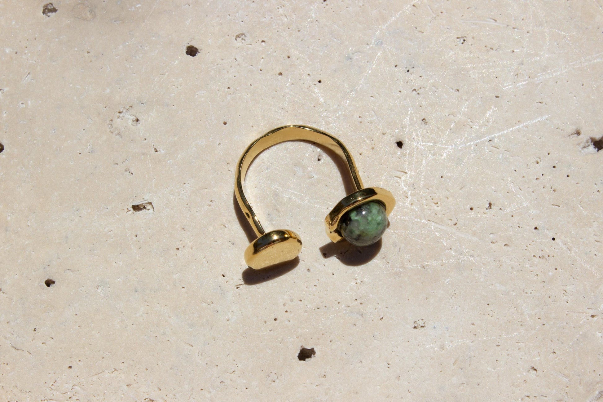 top angle of gold ring with green turqiouse gemstone.
