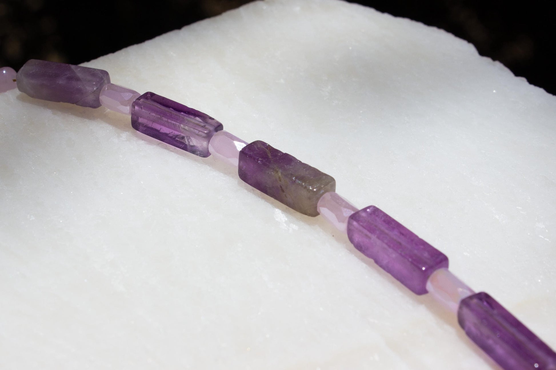 close up of square amethyst beads on a necklace.