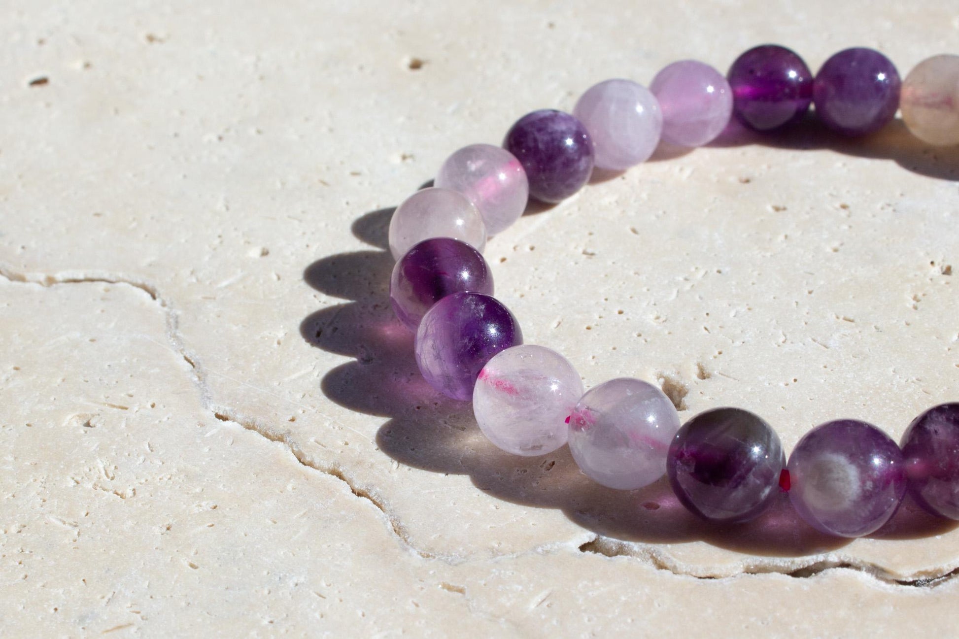 close up on the details of amethyst crystal in a beaded stretch bracelet.