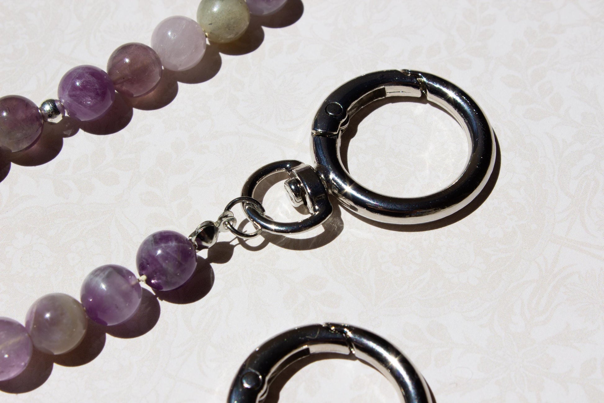 close up of bag charm silver rings.