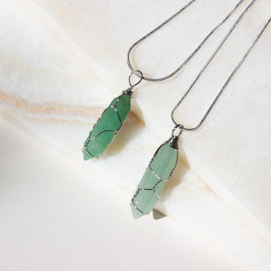 two wire wrapped green aventurine necklaces on a white background.