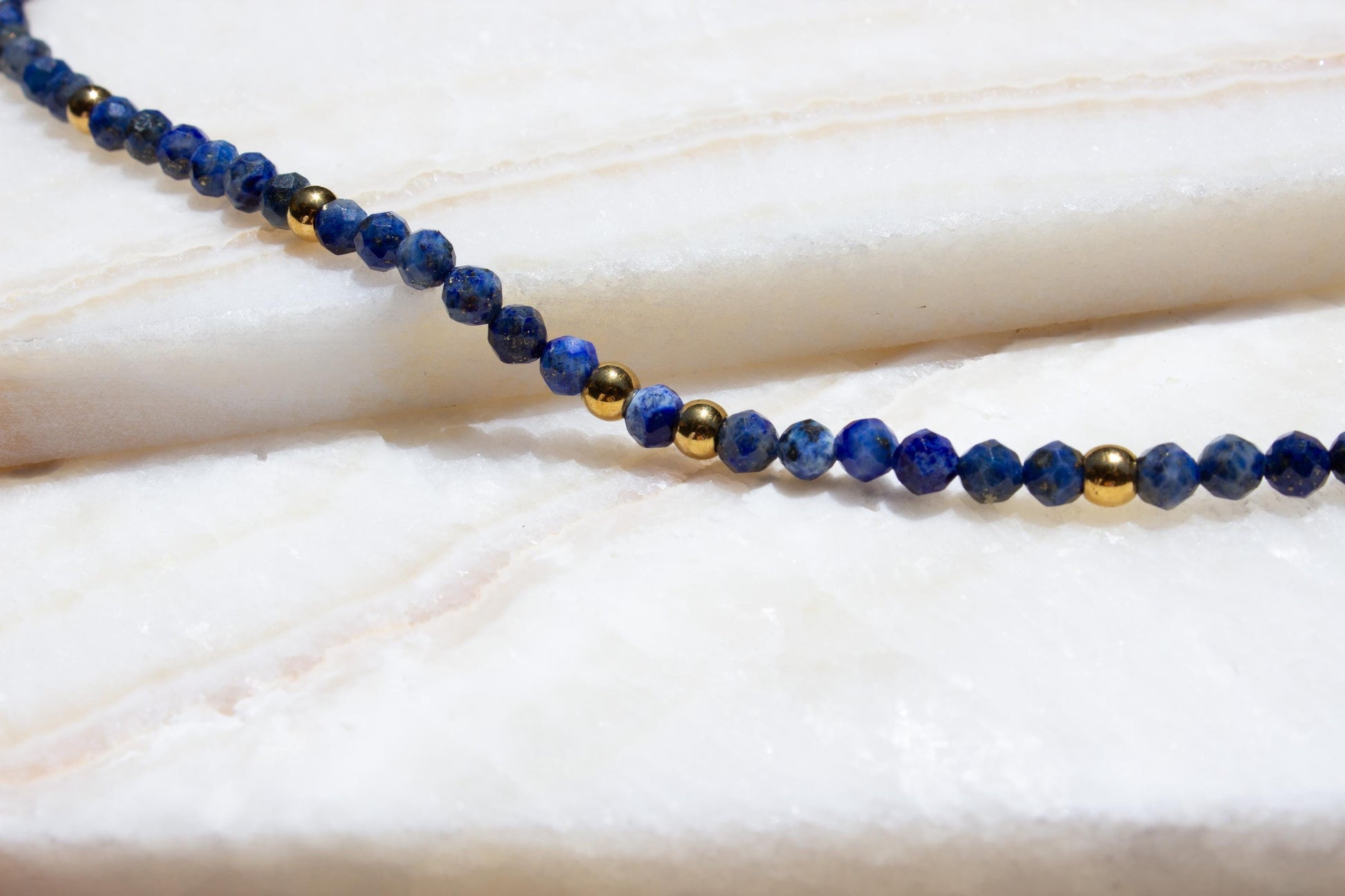 close up of lapis lazuli beaded necklace with gold beads.