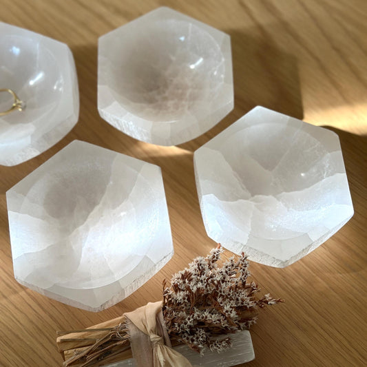 group of small selenite charging bowls in hexagon shape.