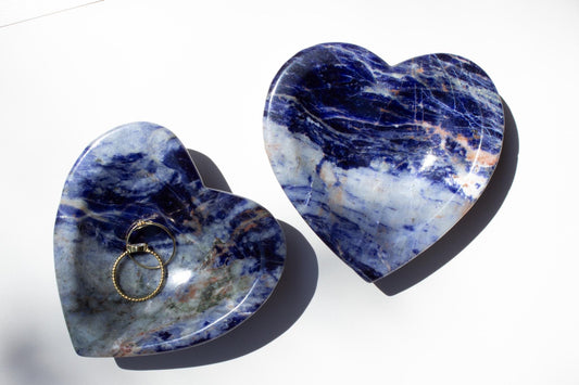 Two crystal bowls in a heart shape. Both bowls are made of sodalite crystal.