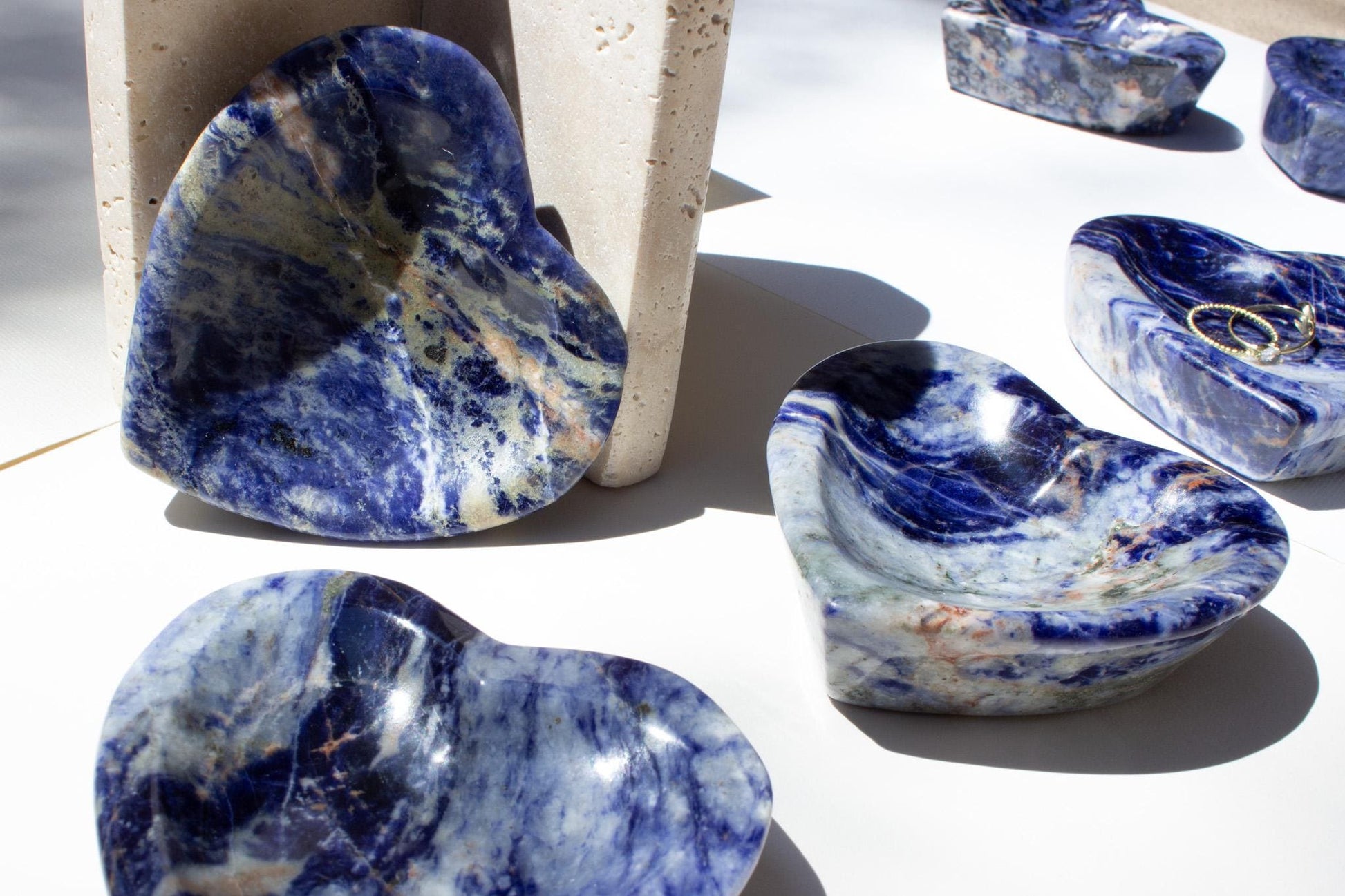 Group of many blue crystal bowls in the sunshine.