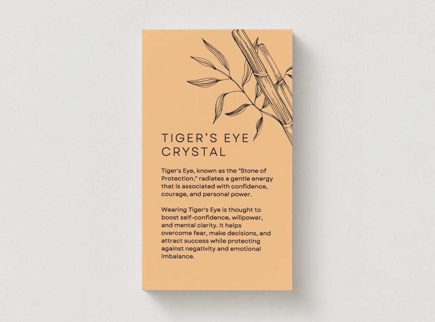 an orange card explaining the energetic properties of tigers eye crystal.
