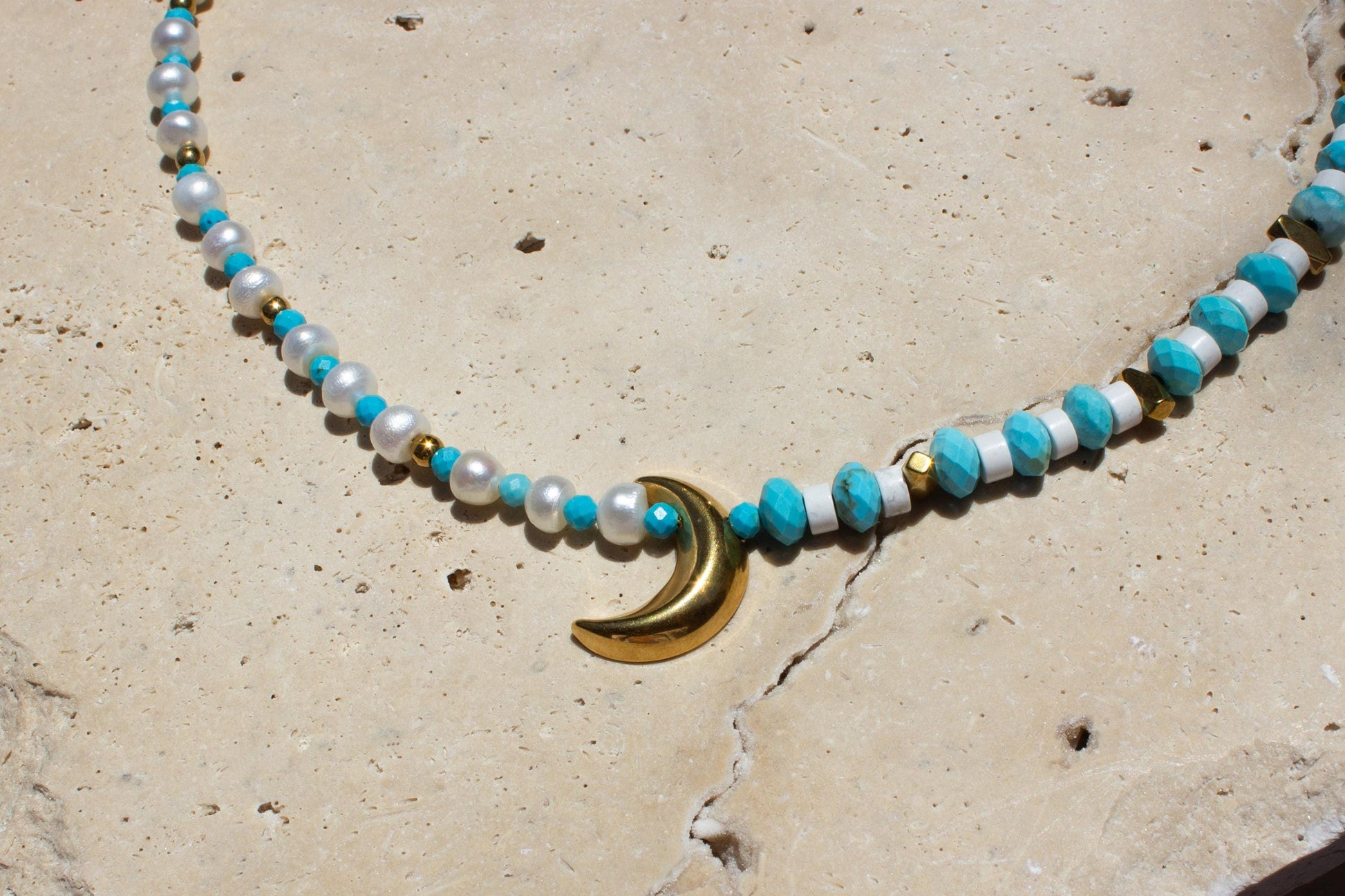 close up of a blue and white beaded choker with gold spacer beads.