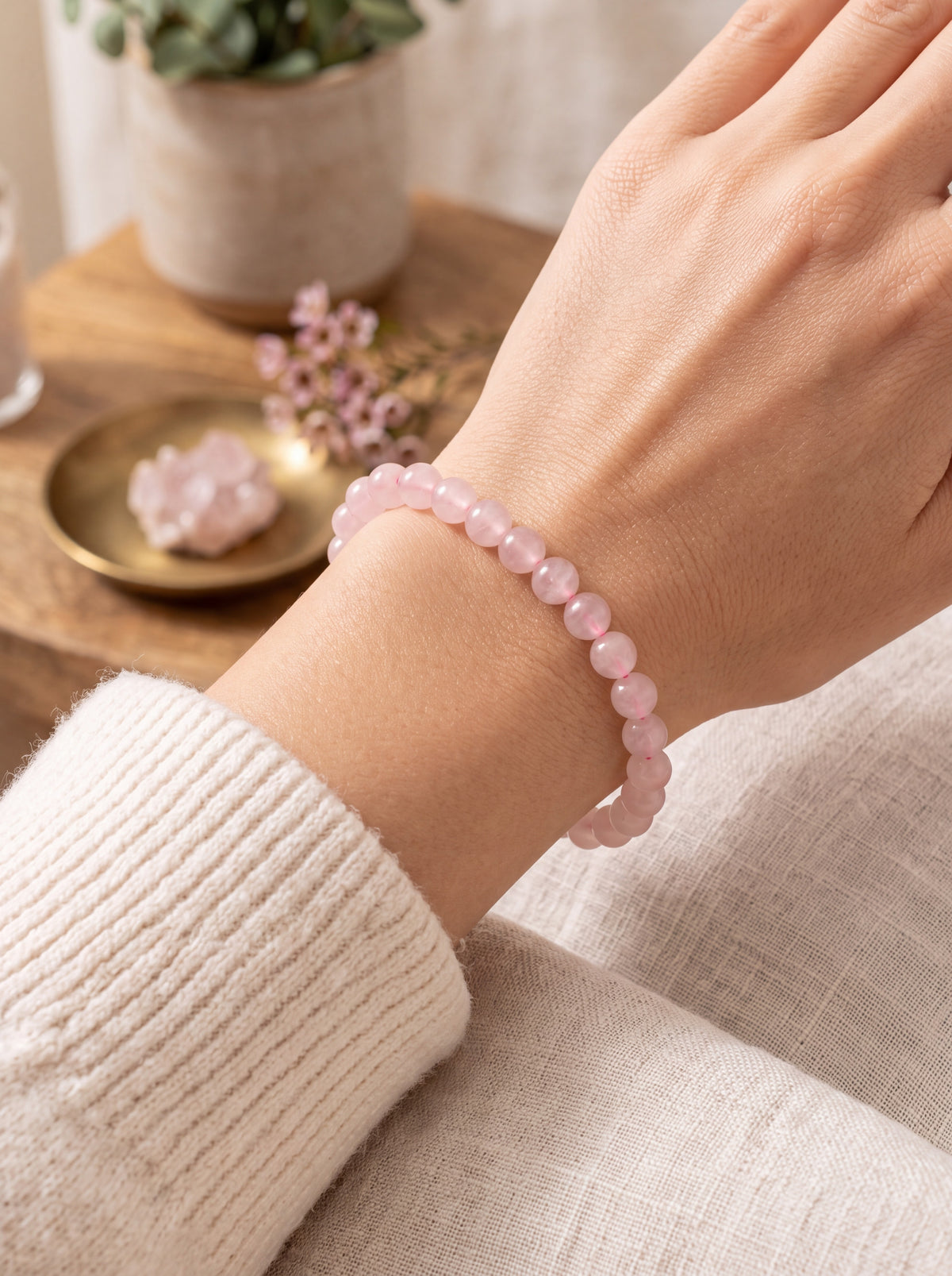 Rose quartz bead bracelet worn on the wrist